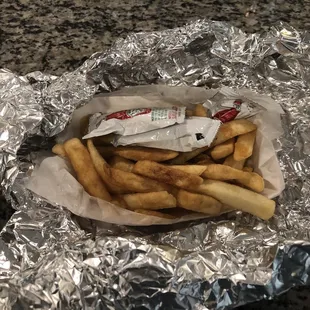 french fries wrapped in aluminum foil