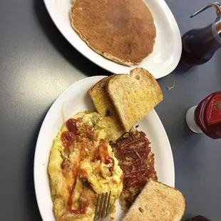 a plate of breakfast food and a plate of pancakes