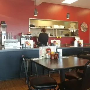 a view of a restaurant with a counter and chairs