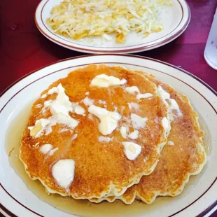 Short stack of pancakes and hashed browns