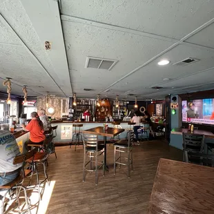 Nautical sconces and bar back tie in the dockside theme.  A new big screen tv was added during the remodel.