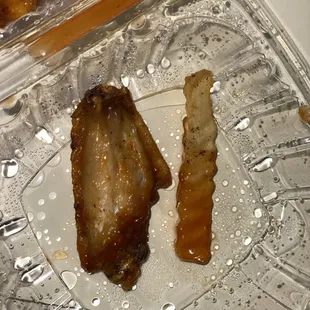 two pieces of meat in a plastic container