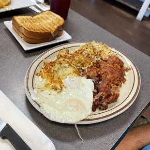 Corned beef hash, hash browns and eggs over med Toast perfectly done!
