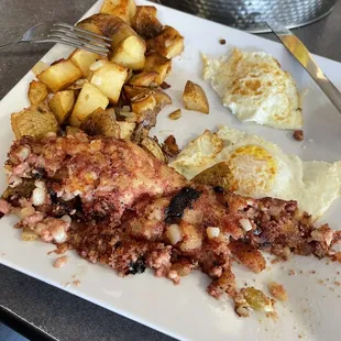 Corned beef hash and eggs over medium with sourdough toast and home fries