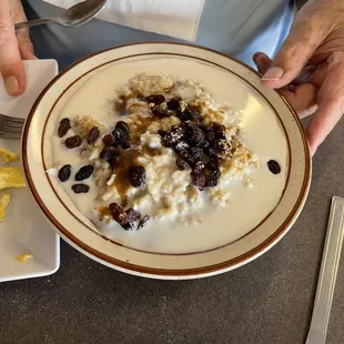 Bowl of oatmeal with raisins, milk and brown sugar!!