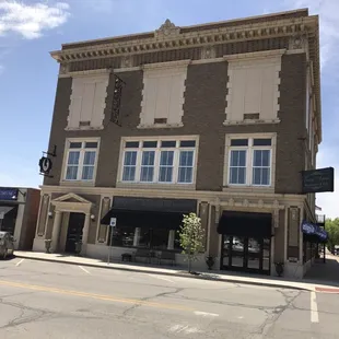 an old brick building on the corner of a street