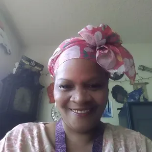 a woman with a pink flowered head wrap