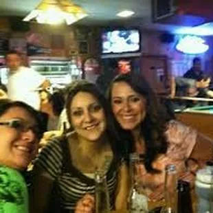 a group of women sitting at a pool table