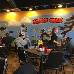 people sitting at tables in a restaurant