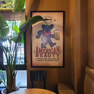 a poster of a bear holding a beer