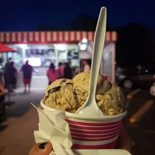 a person holding a bowl of ice cream