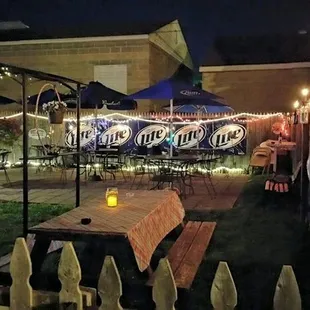 a patio with tables and umbrellas