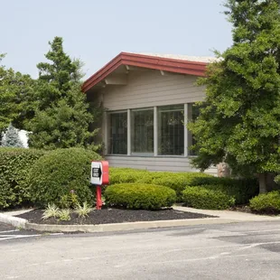 a red mailbox in front of a building