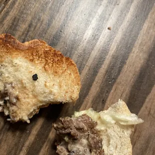 Hard chunks/pieces of the grill I'm assuming. It's hard &amp; gritty.