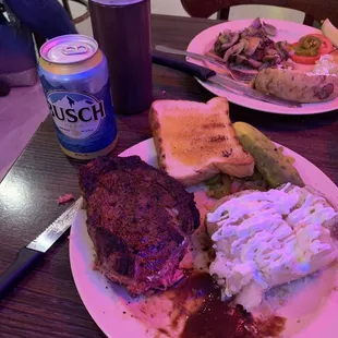 Large ribeye with baked potato, jalapeños, tomatoes, pickle, Texas toast