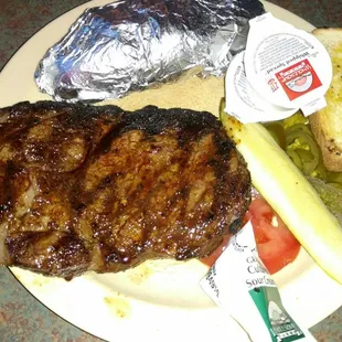 Ribeye. Baked potato. Pickle. Jalapenos. And tomato.