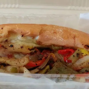a hot dog with onions and peppers