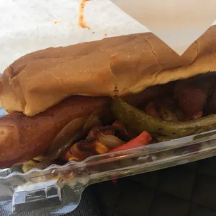 a hot dog with peppers and onions
