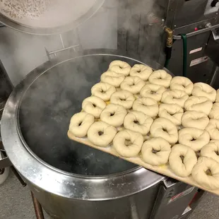 Bagels going into a boiling kettle