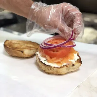 Finishing touches on a Nova Lox Sandwich