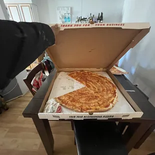 a slice taken out of a pizza box