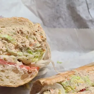 a hand holding a sandwich