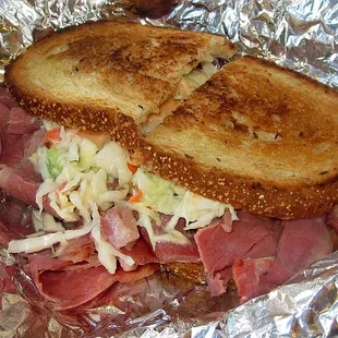 a roast beef sandwich with coleslaw