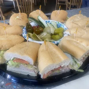 Sandwich tray with pickle assortment.