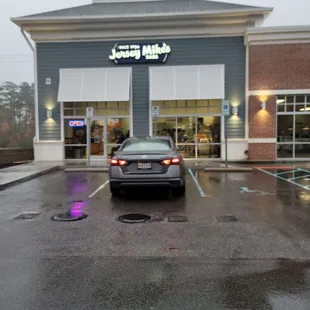 a car parked in front of the store