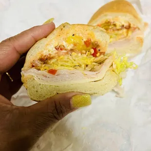 Turkey Provolone Mike&apos;s Way fully loaded with mayo, lettuce, tomatoes, banana peppers, onions, and red chili pepper sauce.