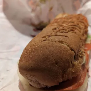 a sub sandwich with meat and cheese