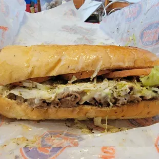 Double steak, double cheese Philly with lettuce, tomatoes, seasoning, and oil.