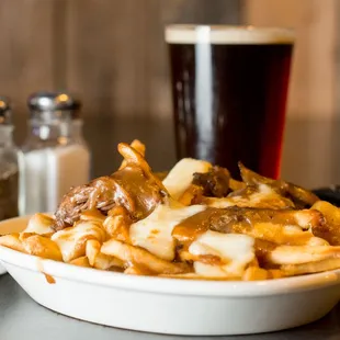 a bowl of fries and a pint of beer