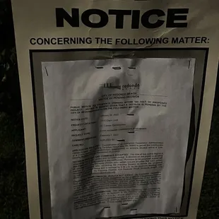 a public notice posted on a pole