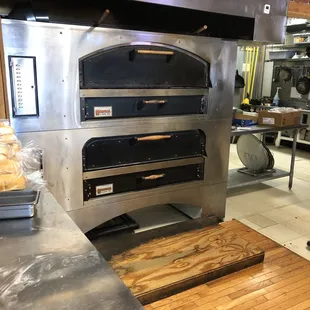 a commercial kitchen with a pizza oven