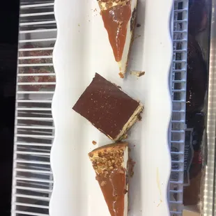 three slices of cheesecake on a white plate