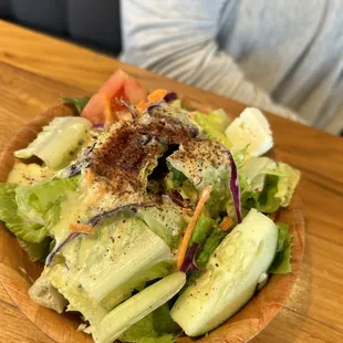 a wooden bowl of salad