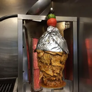 a chicken skewer being cooked in a commercial kitchen