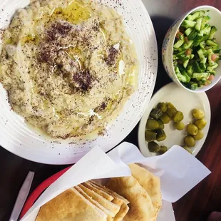 a bowl of hummus and pita bread