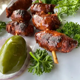 a plate of meat skewers