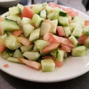 a plate of chopped tomatoes and cucumbers