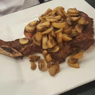 Rib steak topped with mushrooms