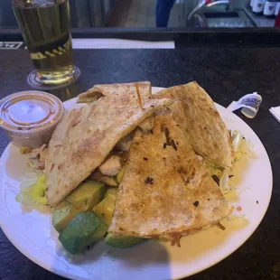 Bar area with a quesadilla salad. Even though it is pizza night .