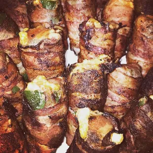 a plate of bacon wrapped in cheese