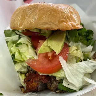 a sandwich with lettuce, tomato, and lettuce