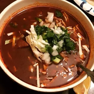 a bowl of soup with meat and vegetables