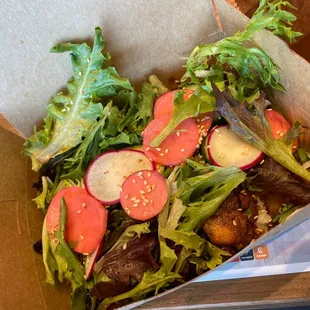 a salad in a cardboard box