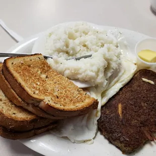 Scrapple and over easy eggs, with grits