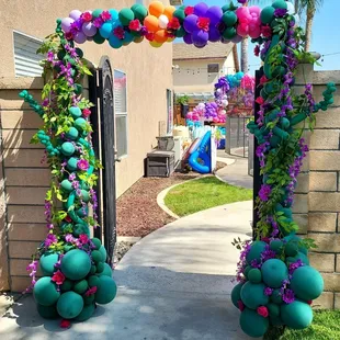 Encanto theme party , entrance with flowers.
