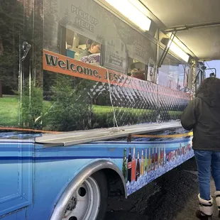 a man standing in front of a food truck